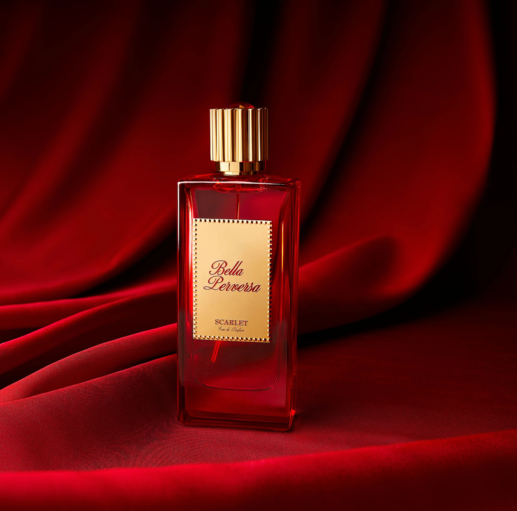 Bella Perversa Scarlet Eau de Parfum for women, 2.5 oz bottle, elegant glass bottle with a deep red cap and floral accents.